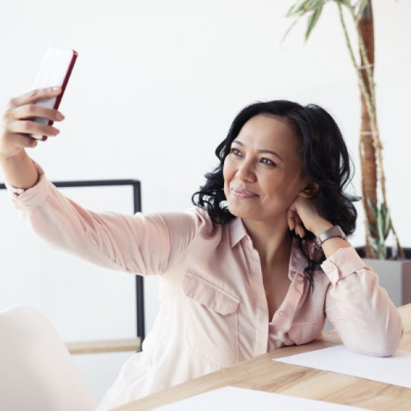 Professional woman taking selfie