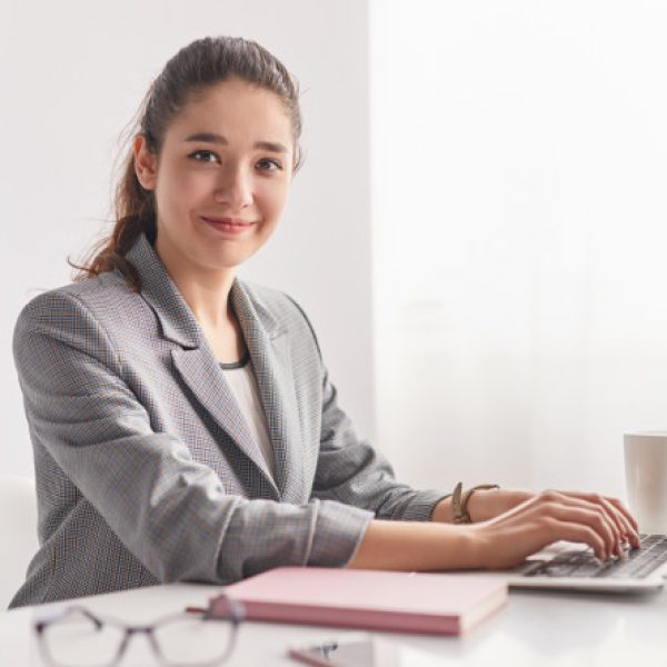 young woman typing on laptop
